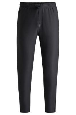 active-stretch tracksuit bottoms with decorative reflective details- black men's jogging pants
