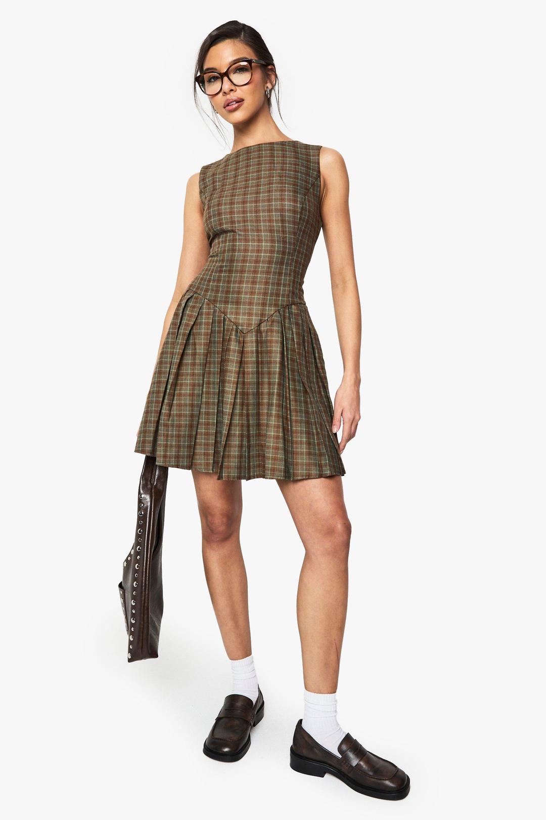 Check Pleated Tailored Dress Check Pleated Tailored Dress – Checked pleated mini dress in polyester‑blend