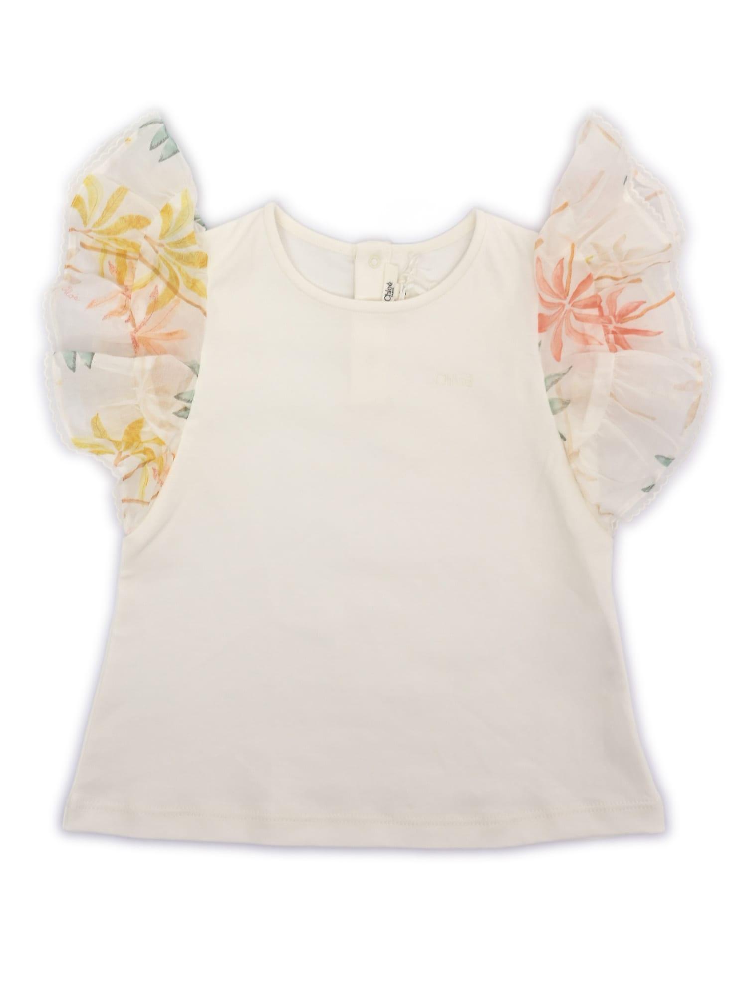chloé short sleeves top in 100% organic cotton interlock. ruffles in 100% organic cotton veil with palm grove seasonal print. tone on tone chlo embroidery