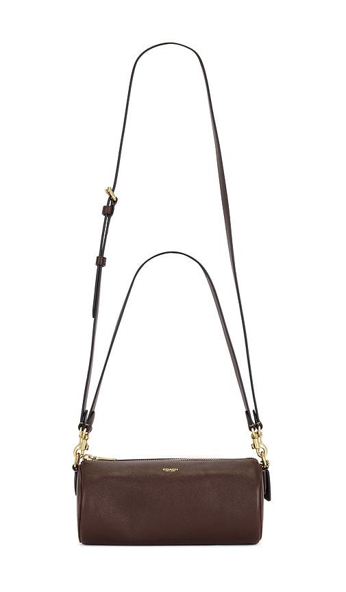 coach natural grain leather barrel bag in brown.