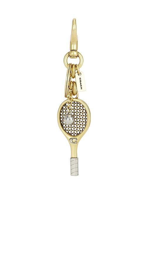 coach small tennis racket bag charm in metallic gold.