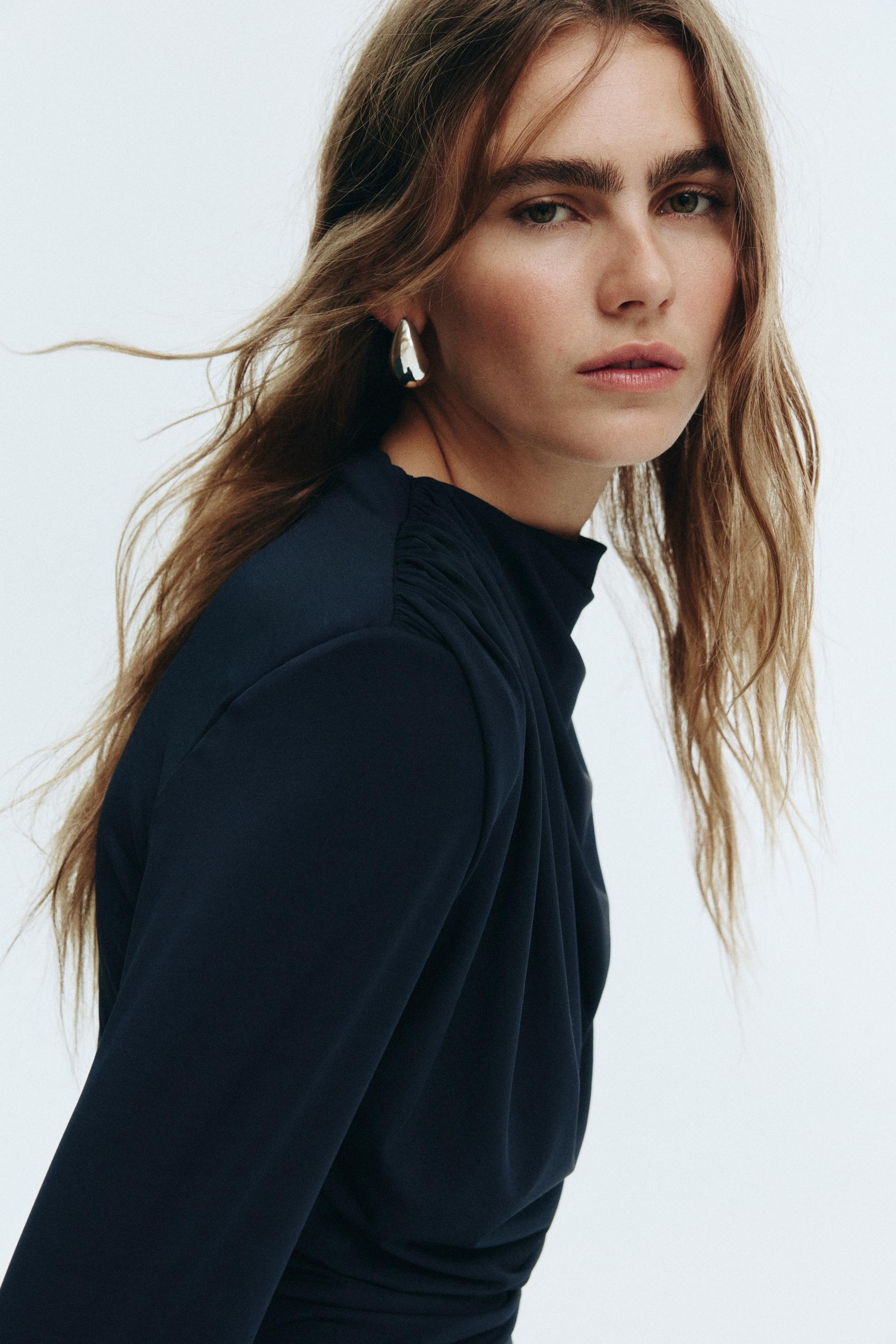 draped dress with shoulder pads