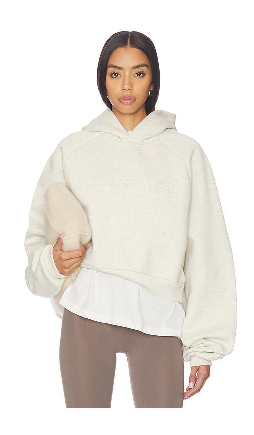 fear of god essentials 90's raglan hoodie in cream.