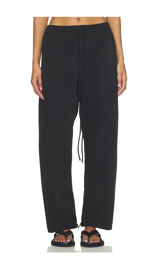 fear of god essentials active trace track pant in black.