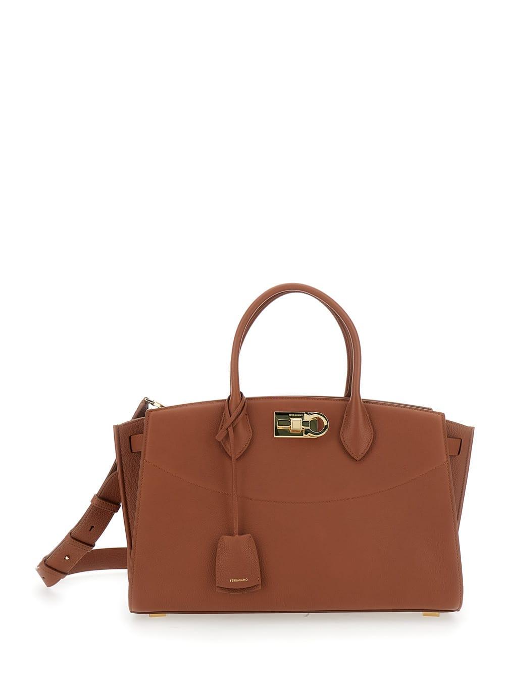 ferragamo brown handbag with adjustable and removable shoulder strap and gancini turn-lock closure in grained leather woman