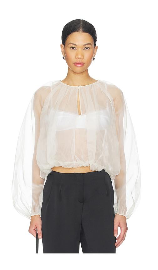frame the sheer balloon blouse in cream.