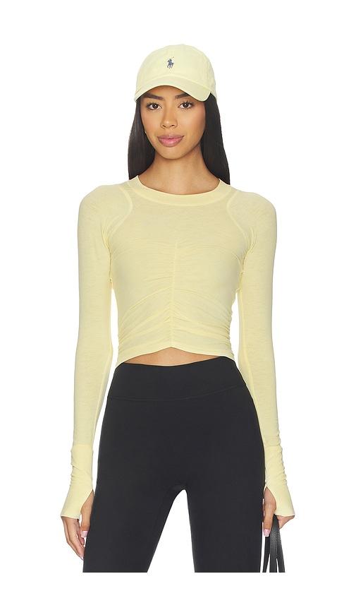 free people x fp movement tempo ruched long sleeve top in yellow.