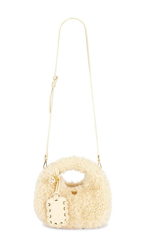 ganni mini fur hobo bag in cream.