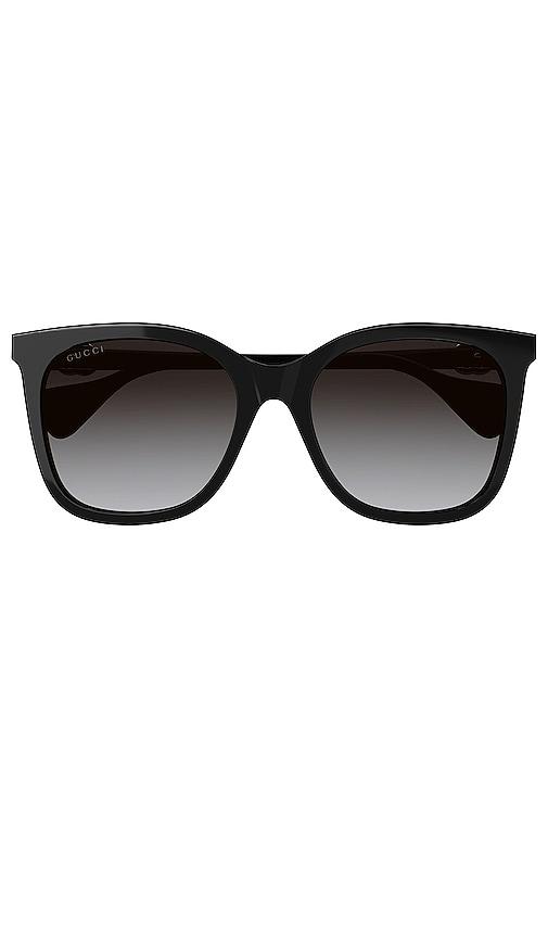 gucci mini running cat eye sunglasses in black.