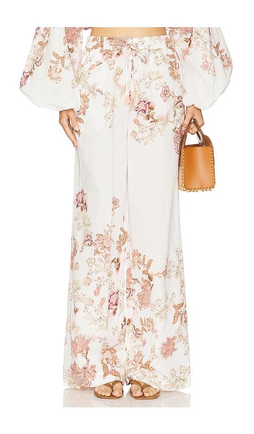 hemant and nandita pull on pant in white.