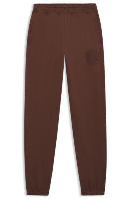 hugo logo-artwork tracksuit bottoms in cotton terry - brown women's pants