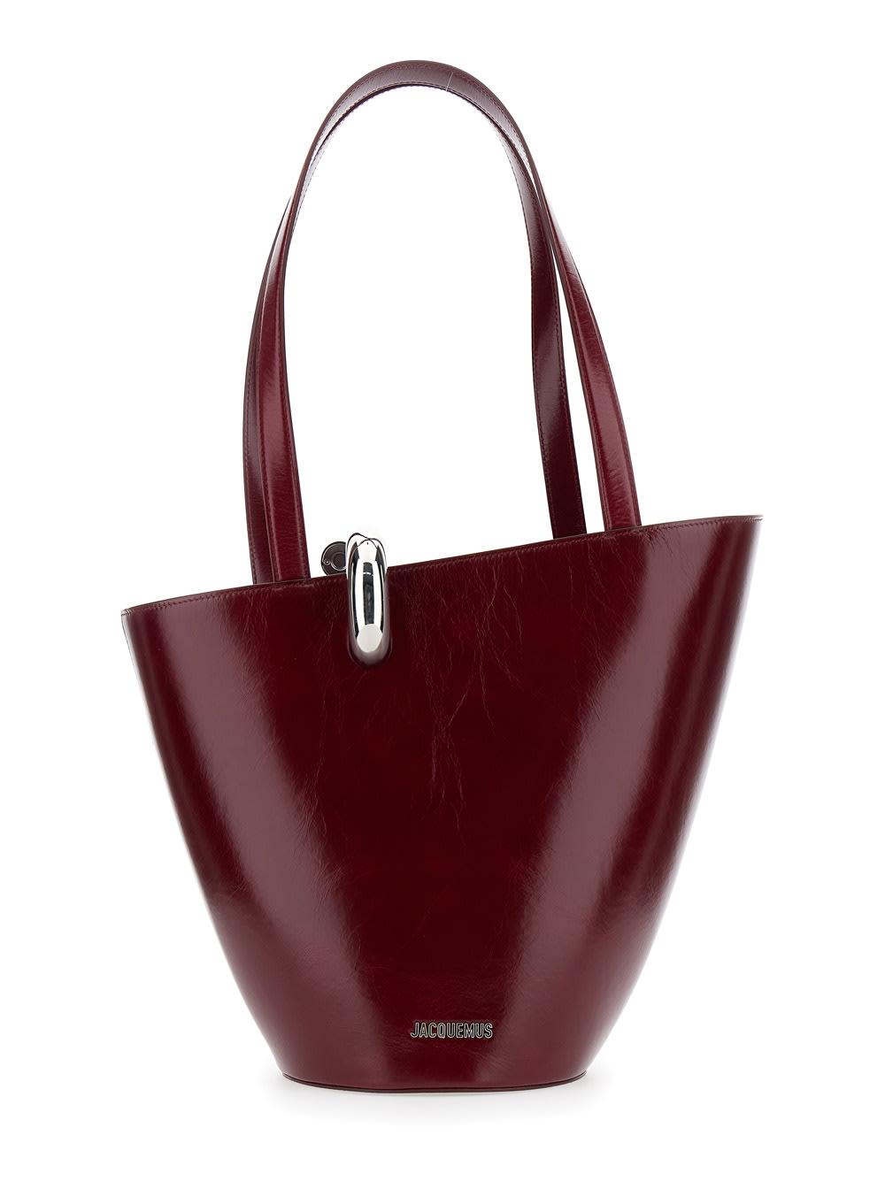 jacquemus le bambola moyen bordeaux shoulder bag with front metal ring closure and embossed logo lettering on the front in leather woman