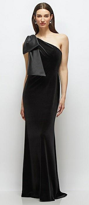 one-shoulder black velvet maxi dress with large trailing satin bow