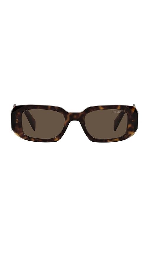 prada scultoreo narrow sunglasses in brown.