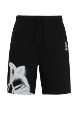 relaxed-fit shorts with floral artwork- black men's clothing
