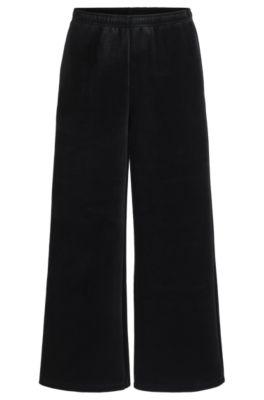 relaxed-fit tracksuit bottoms in stretch velour- black women's pants