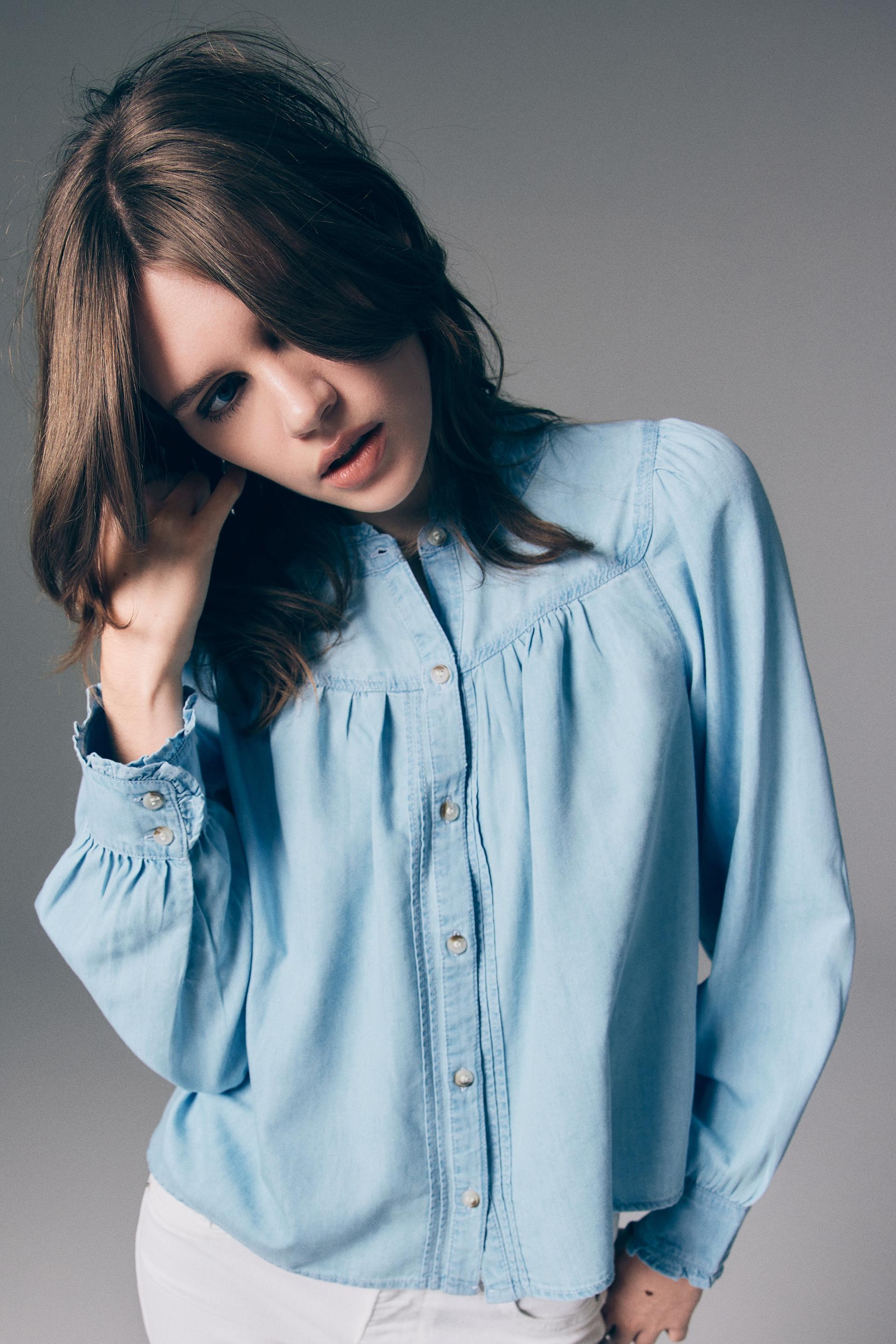 ruffle-trimmed denim blouse
