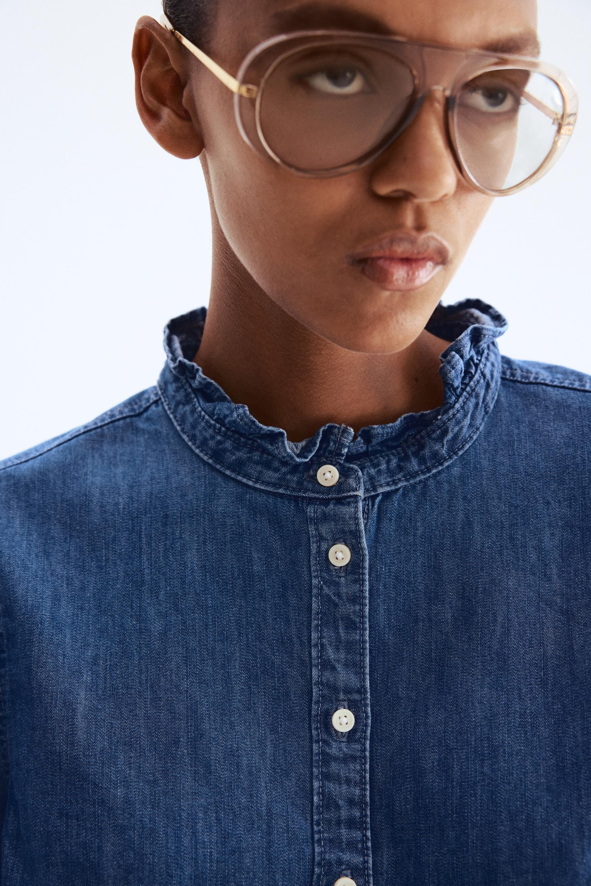 ruffle-trimmed denim blouse