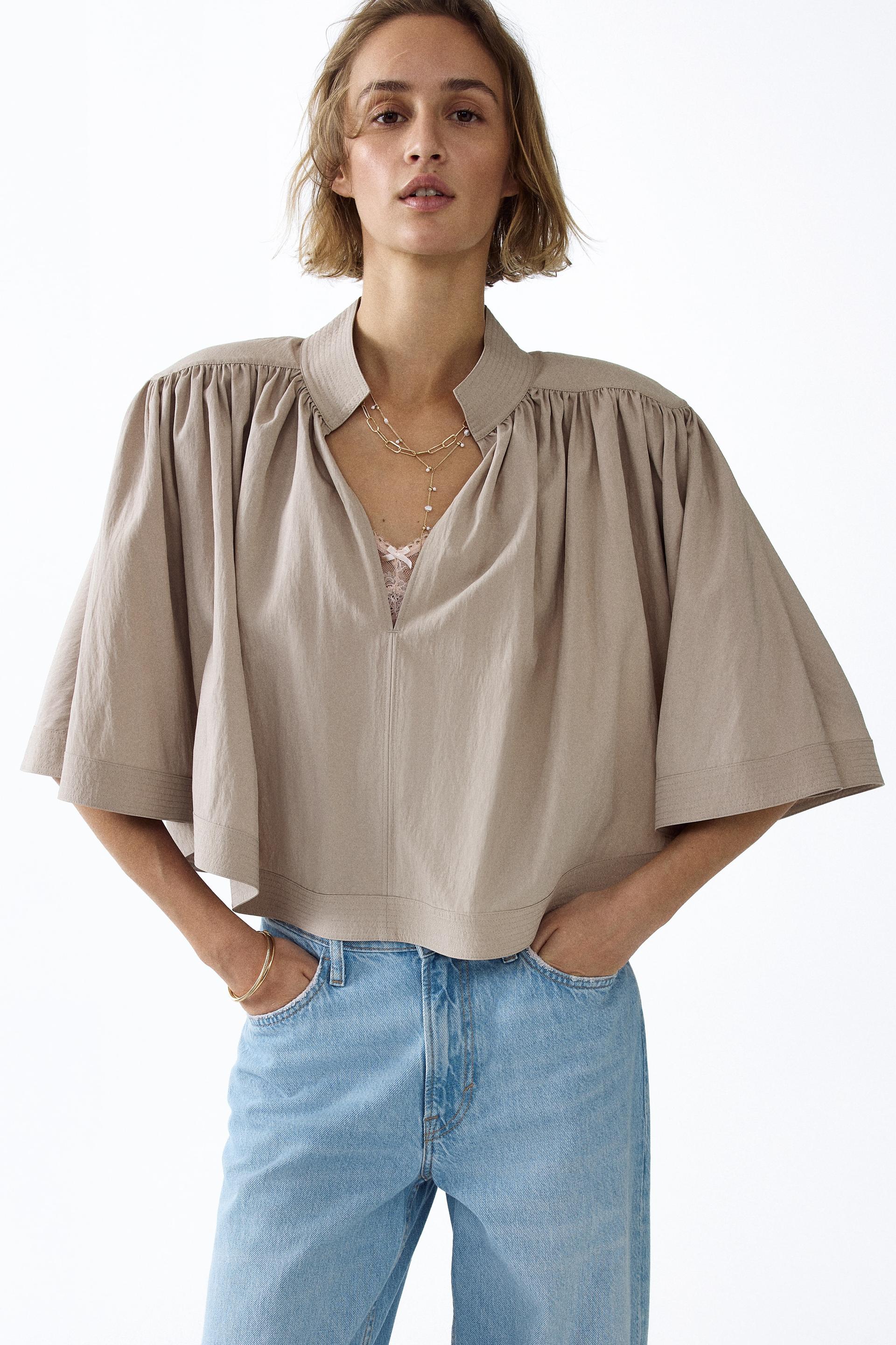 shoulder-pad cape blouse