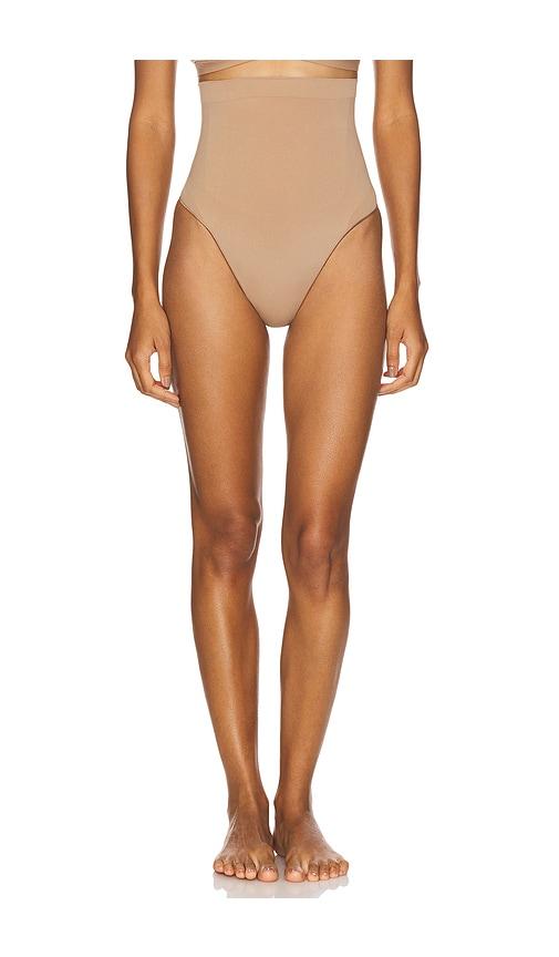 skims seamless sculpt high waist thong in beige.