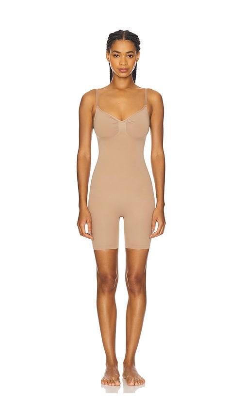 skims seamless sculpt mid thigh bodysuit in beige.