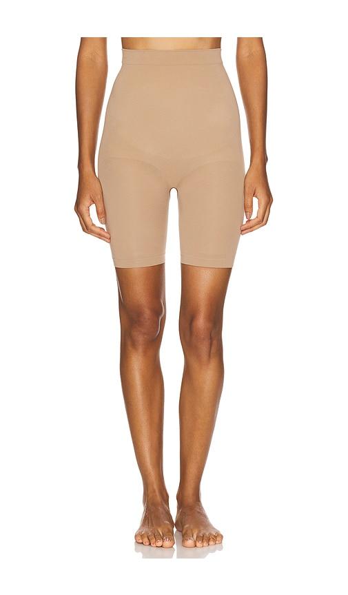 skims seamless sculpt mid thigh short in beige.