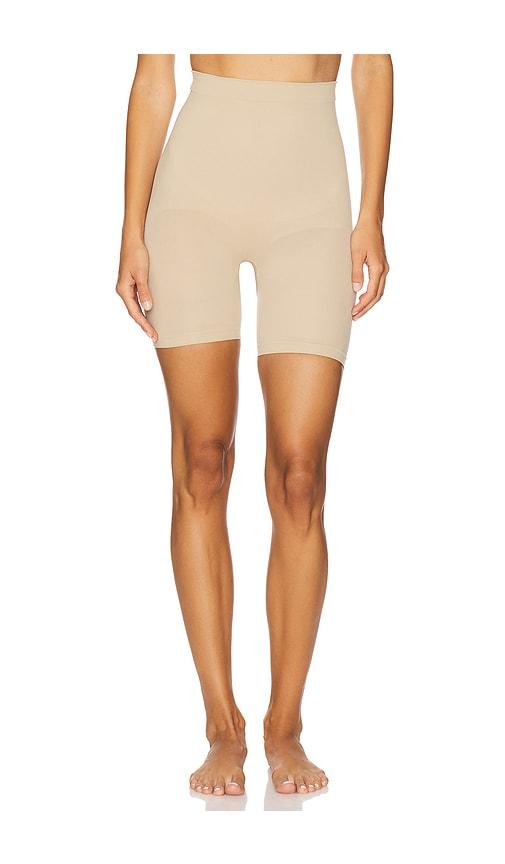 skims seamless sculpt mid thigh short in tan.
