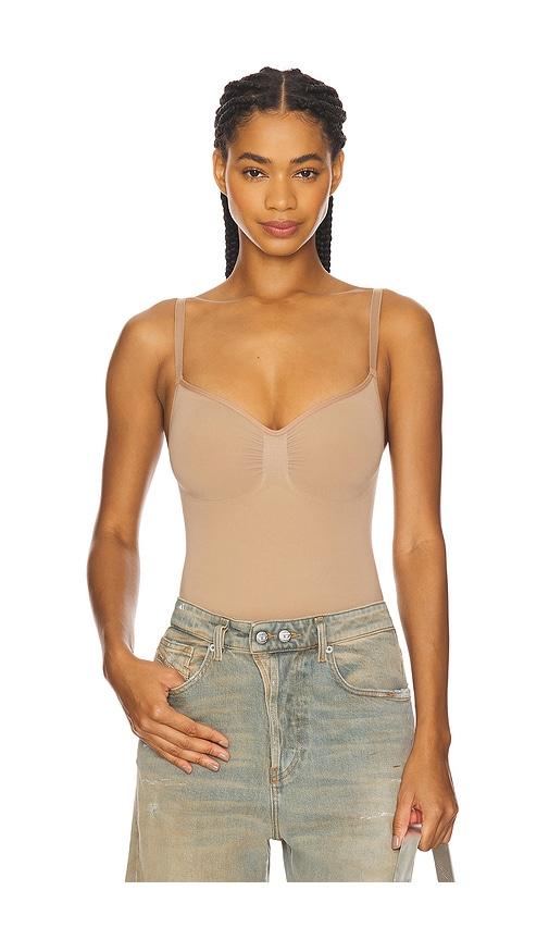 skims seamless sculpt thong bodysuit in beige.