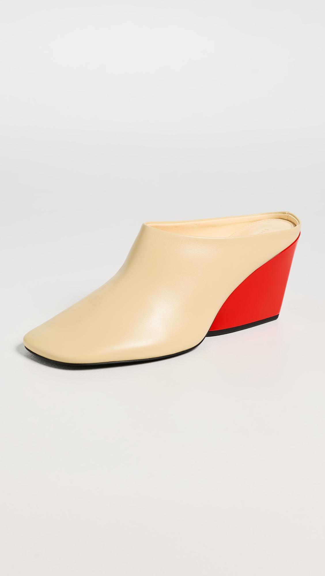 slant mules in slick calf