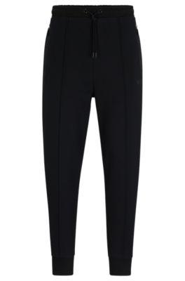 tracksuit bottoms with pixelated details- black men's jogging pants