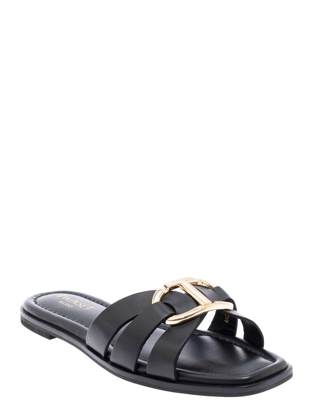 twinset black sandals with crisscross strap and metallic oval t on the front in leather woman