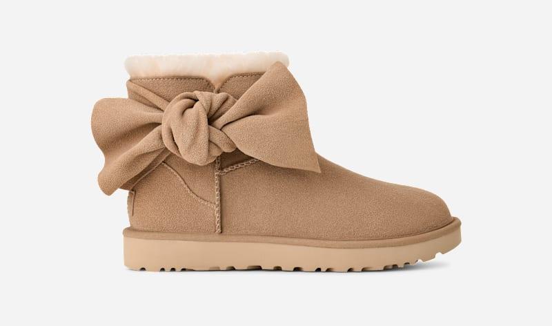 ugg® women's classic mini bow suede classic boots in sand,